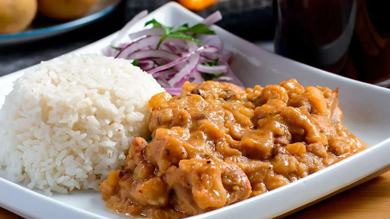 Authentic Peruvian carapulcra, a traditional stew made with dried potatoes, pork, and rich peanut sauce, garnished with rice.