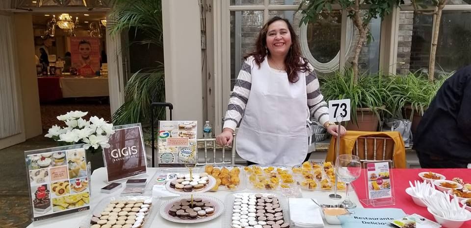 Rosa, the Peruvian cook and founder of Rosi Peruvian Catering, smiling proudly in her kitchen while preparing traditional homemade dishes